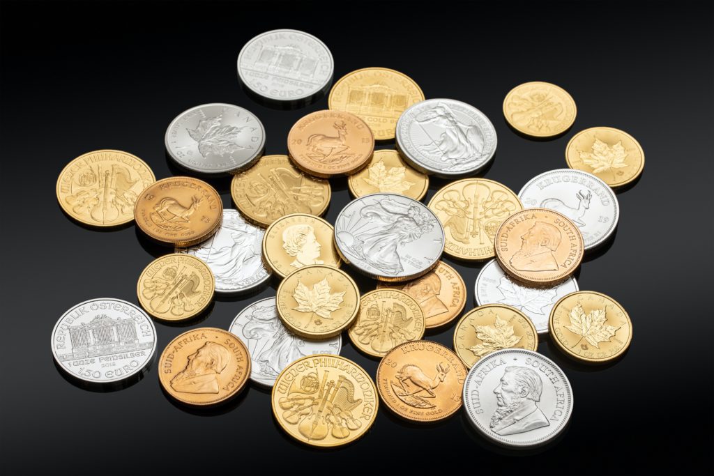 gold and silver coins scattered on black background